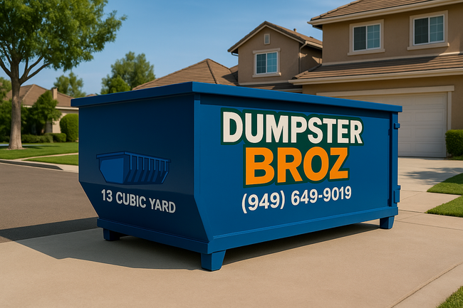 A black dumpster is sitting on top of a white surface.