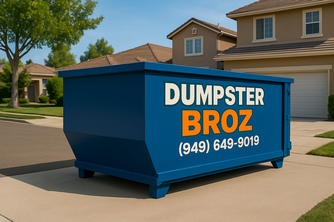 A black dumpster is sitting on top of a white surface.