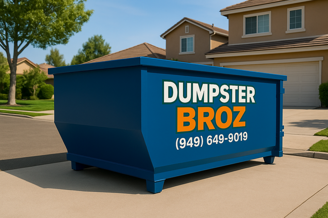 A black dumpster is sitting on top of a white surface.
