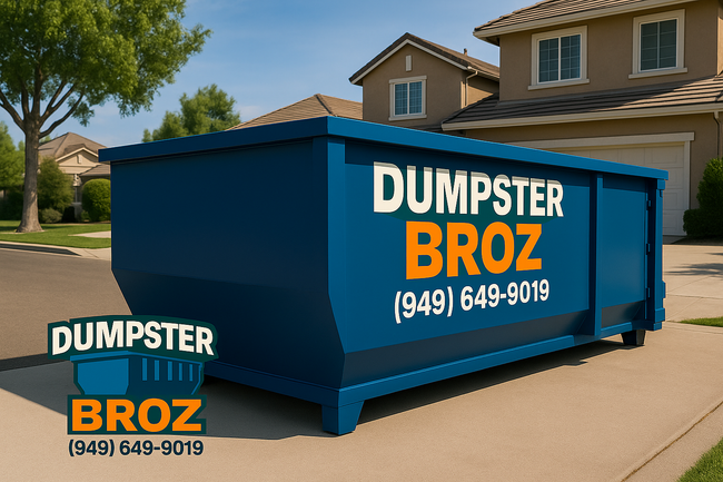 A black dumpster is sitting on top of a white surface.