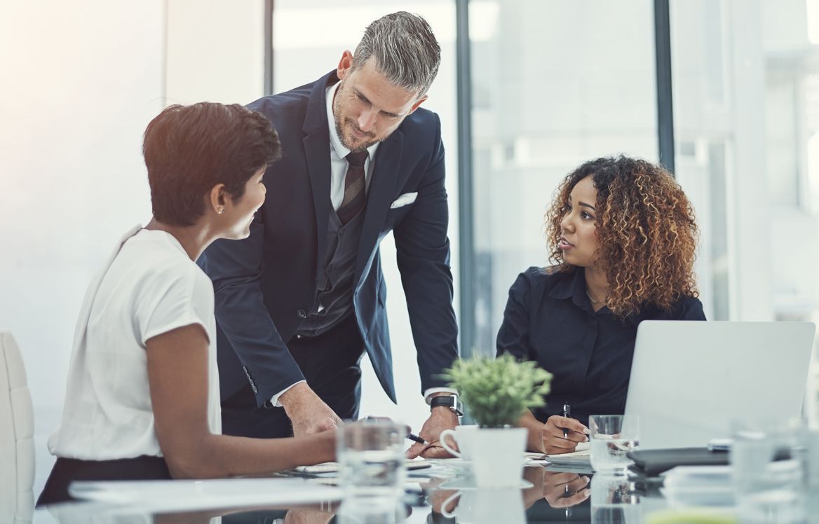 A group of business people are having a meeting in an office.