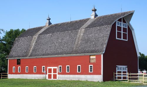 A large red barn with a curved roof