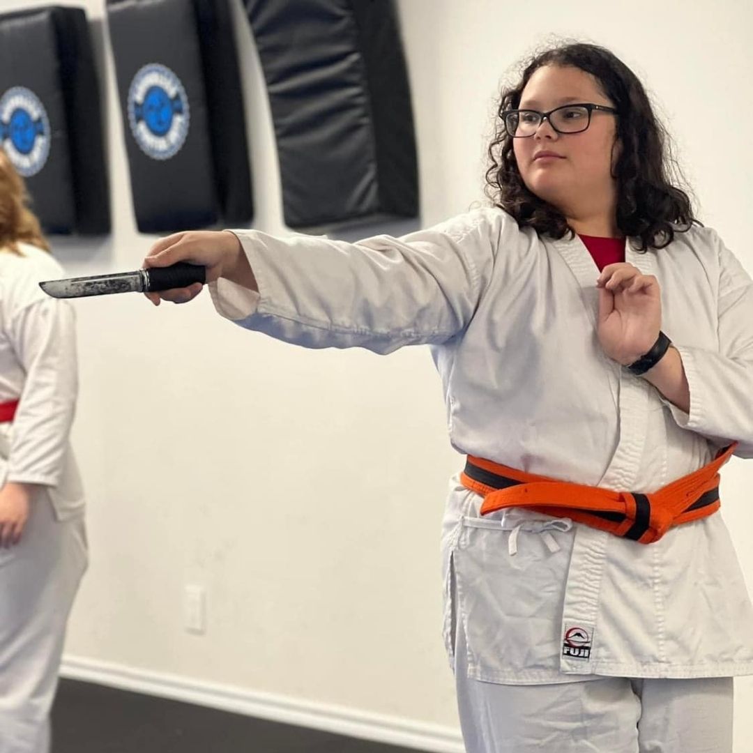 Four men in athletic gear, posing for a photo in a gym.