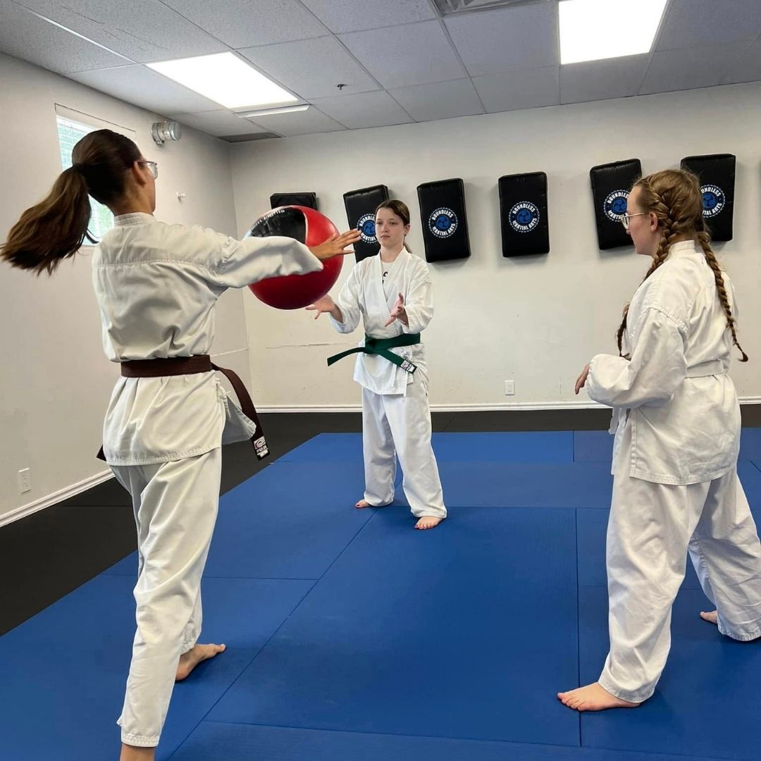 Two men grappling on a mat, one in blue, the other in black.