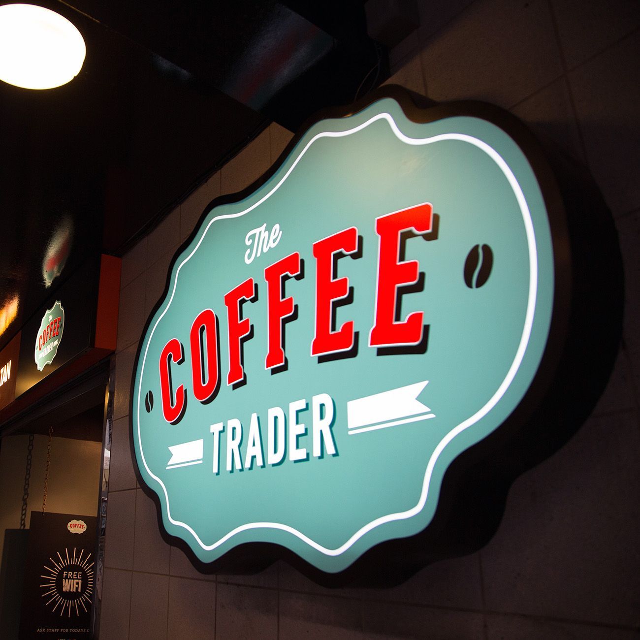 Coffee Trader logo design on illuminated sign