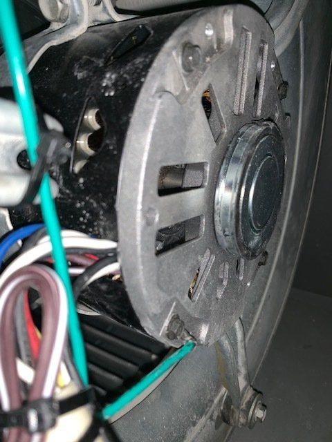 A close up of a motor with wires attached to it