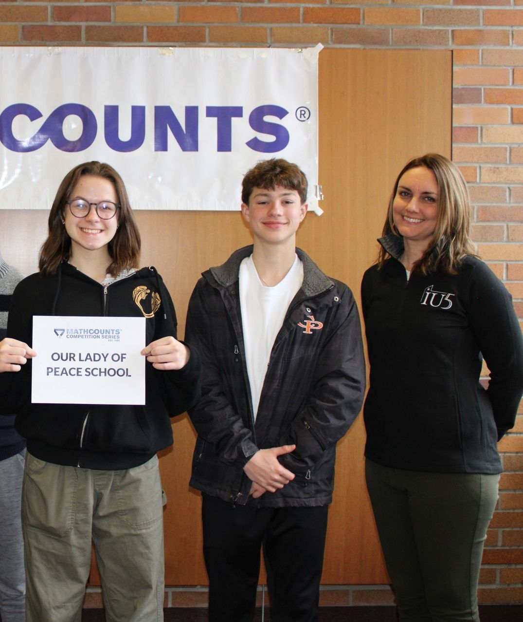 A group of people standing in front of a sign that says counts