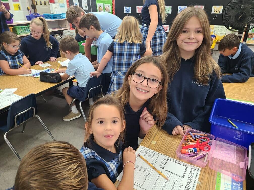 A group of children are posing for a picture in a classroom