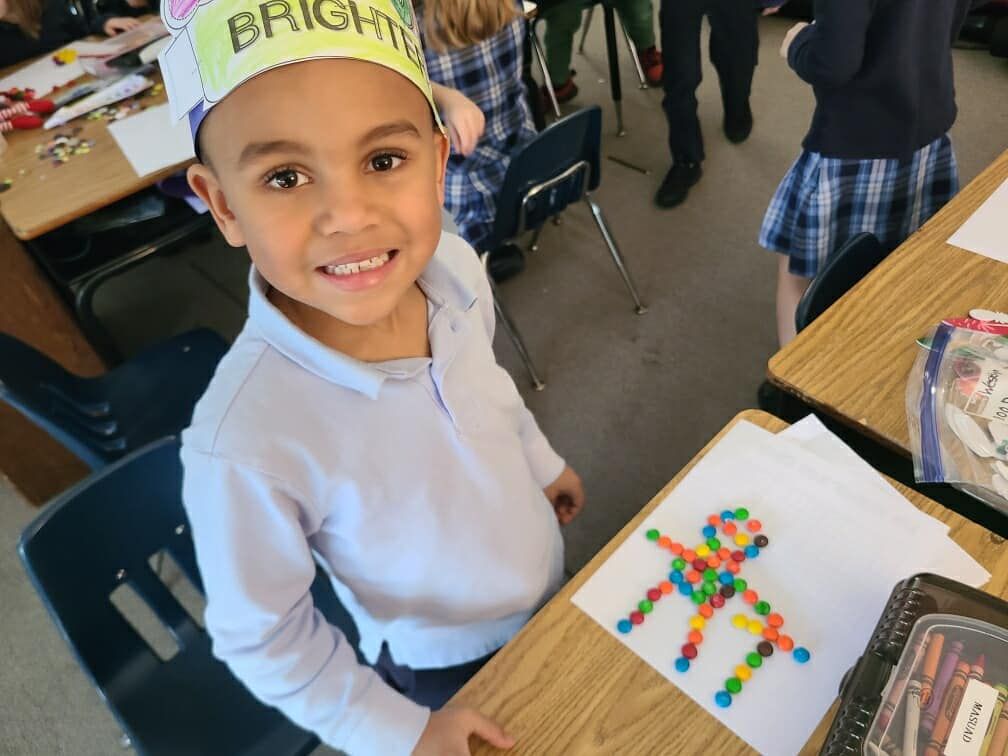A young boy wearing a hat that says bright on it