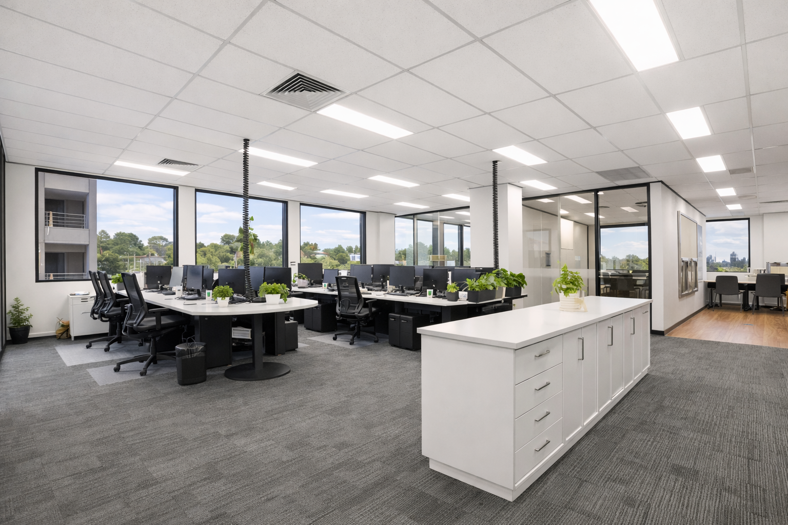 a clean and tidy office space with large windows