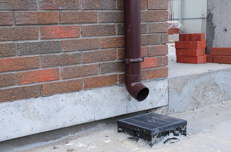 a gutter pipe beside the wall