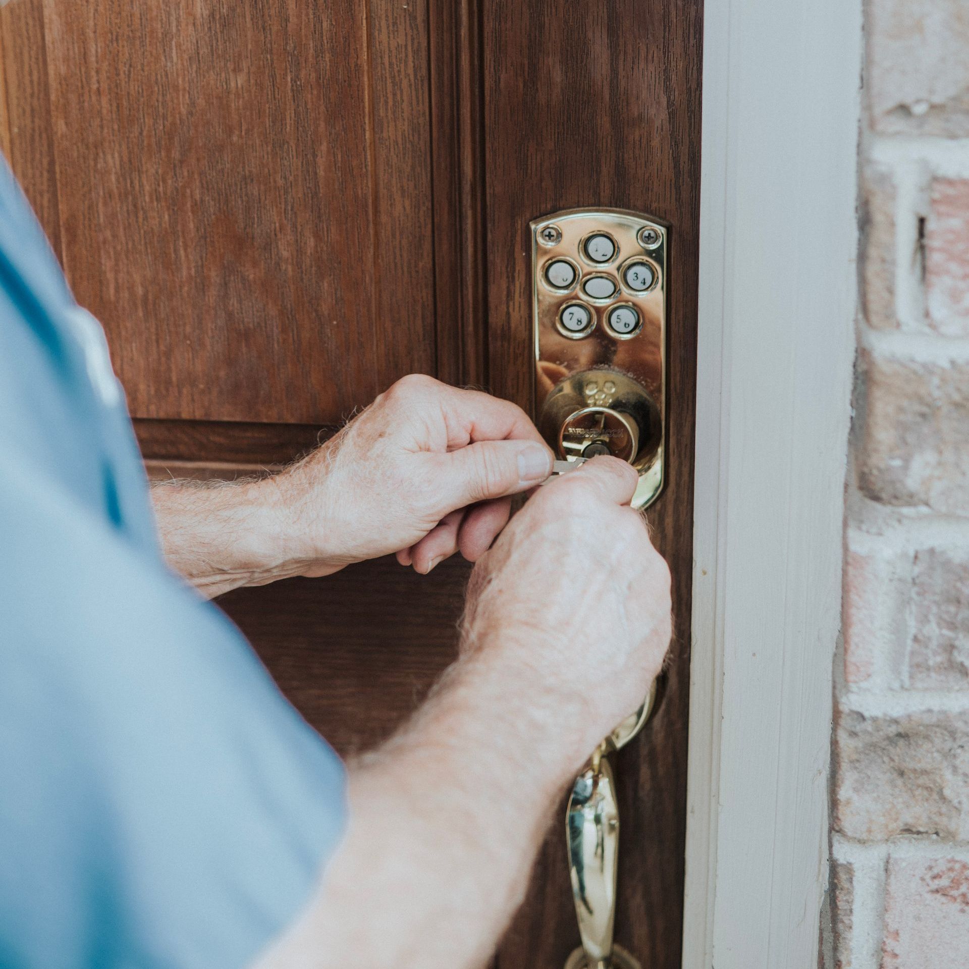 A close up of a door lock on a stainless steel surface