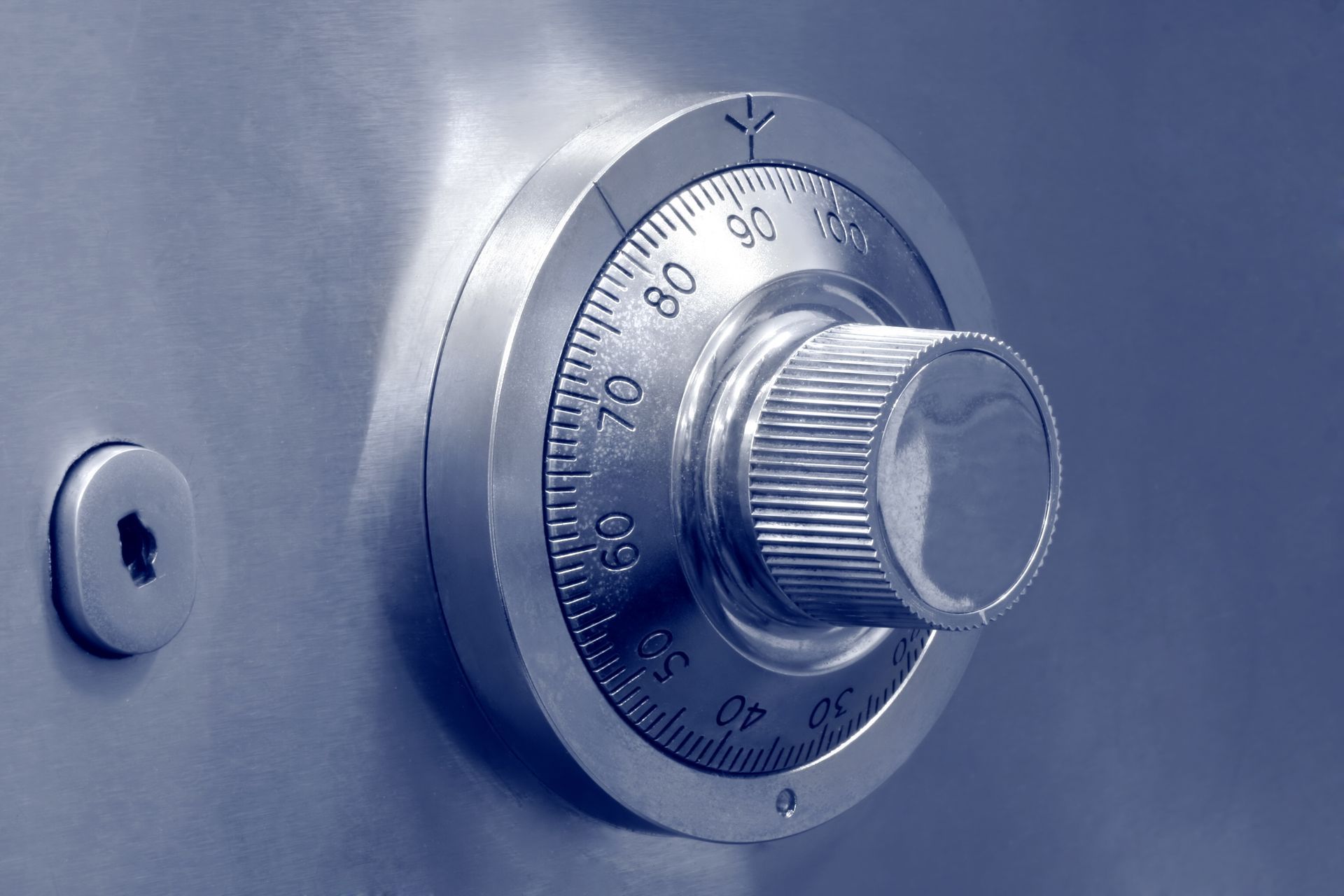 Close-up of combination lock and keyhole on safe, symbolizing secure storage and protection.