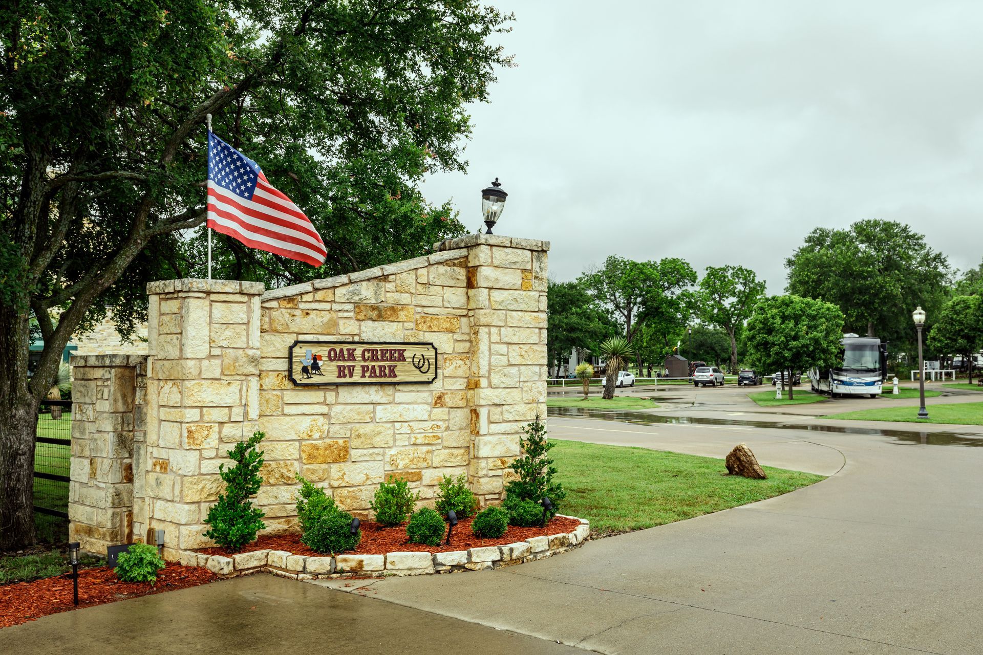 A stone wall with a sign that says oklahoma rv park