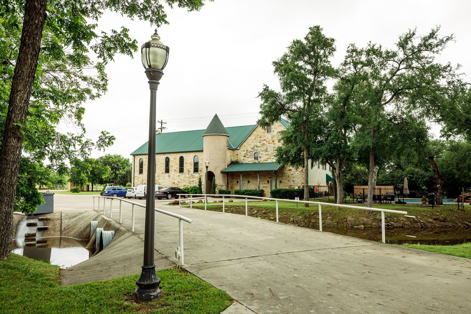 A church with a green roof is behind a street light
