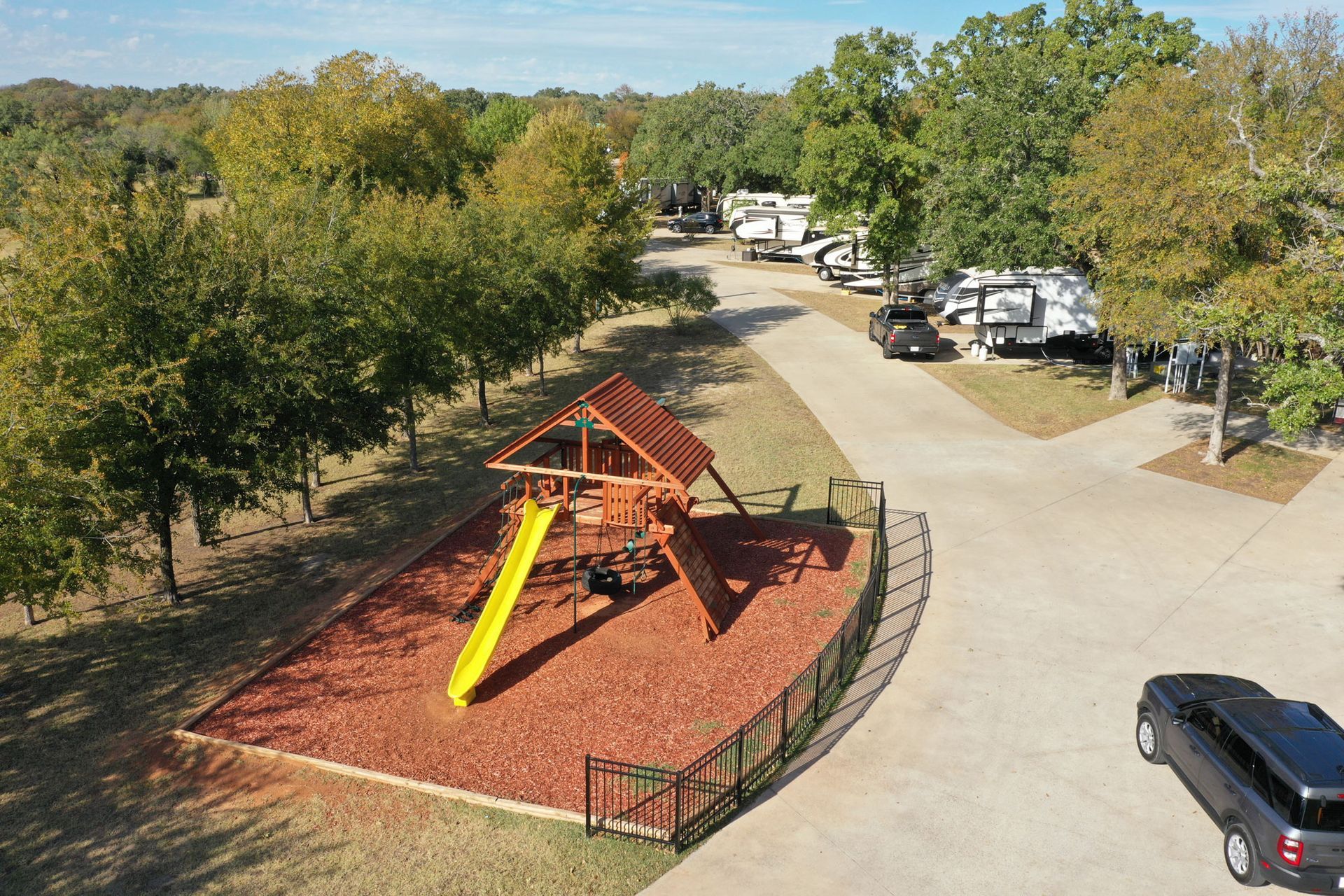 An aerial view of a playground with a slide in a park.