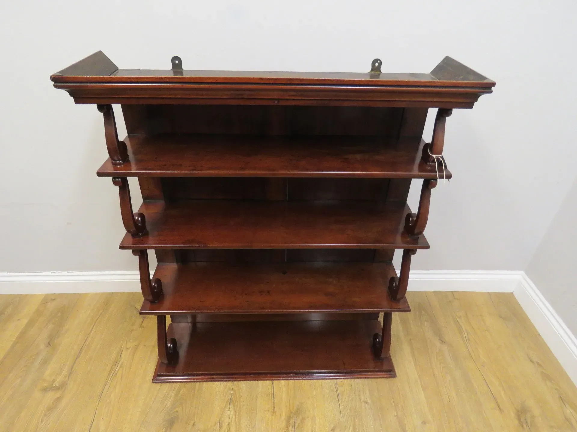 An early Victorian Mahogany Waterfall open hanging bookshelf in its original condition. 2