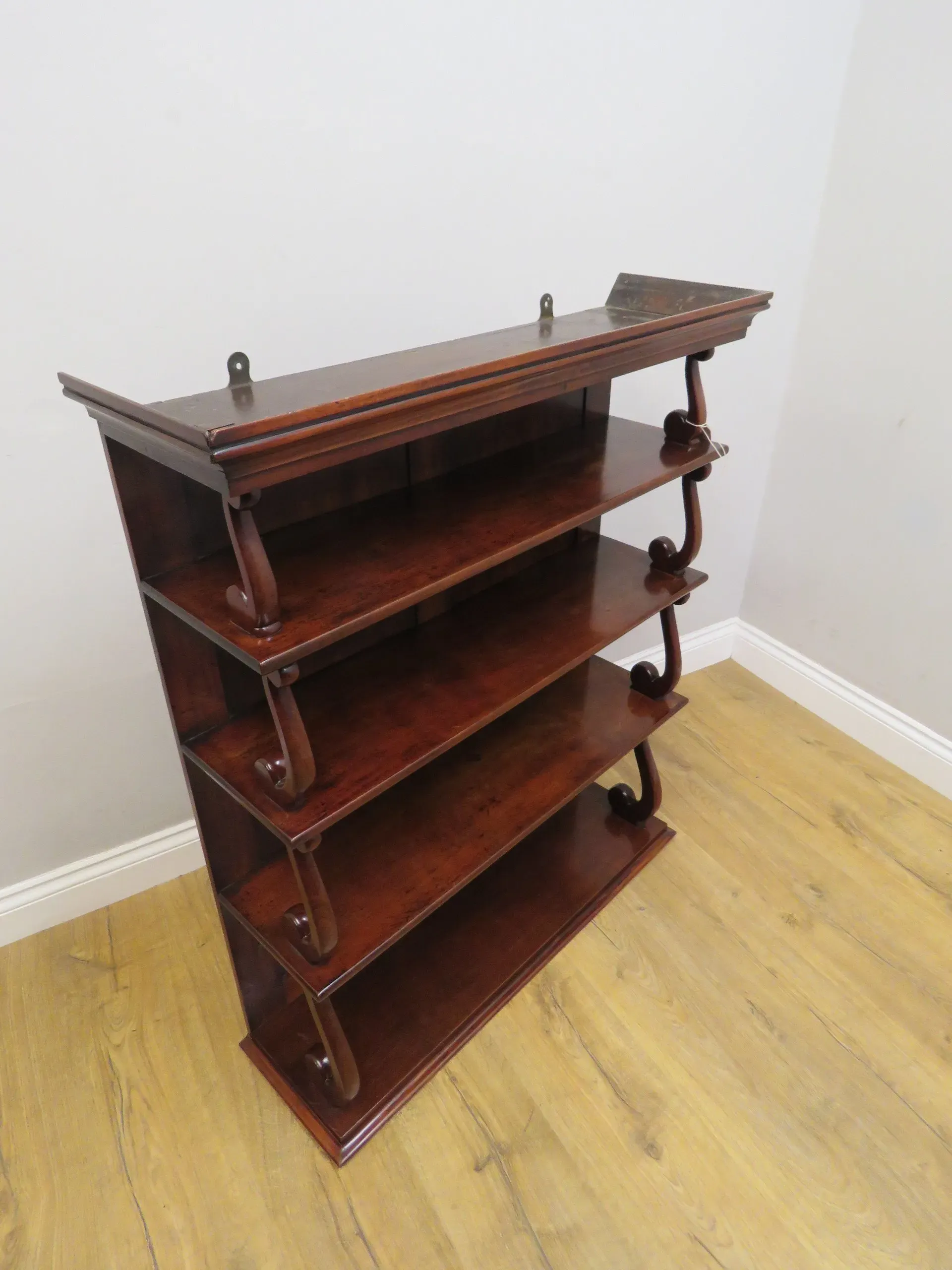An early Victorian Mahogany Waterfall open hanging bookshelf in its original condition. 1