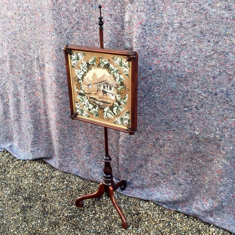 A mid Victorian mahogany pole screen with a finely worked tapestry panel. Size: 54,5