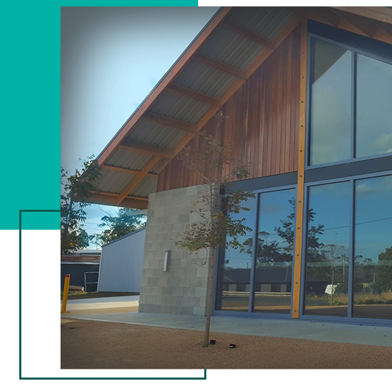 A large building with a tree in front of it A large building with a tree in front of it