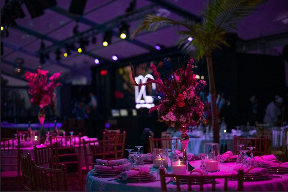 A banquet hall with tables and chairs set up for a party.