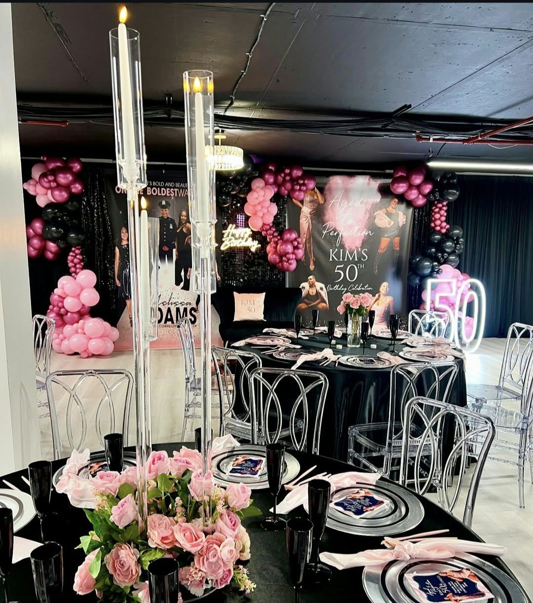 A room with tables and chairs set up for a 50th birthday party