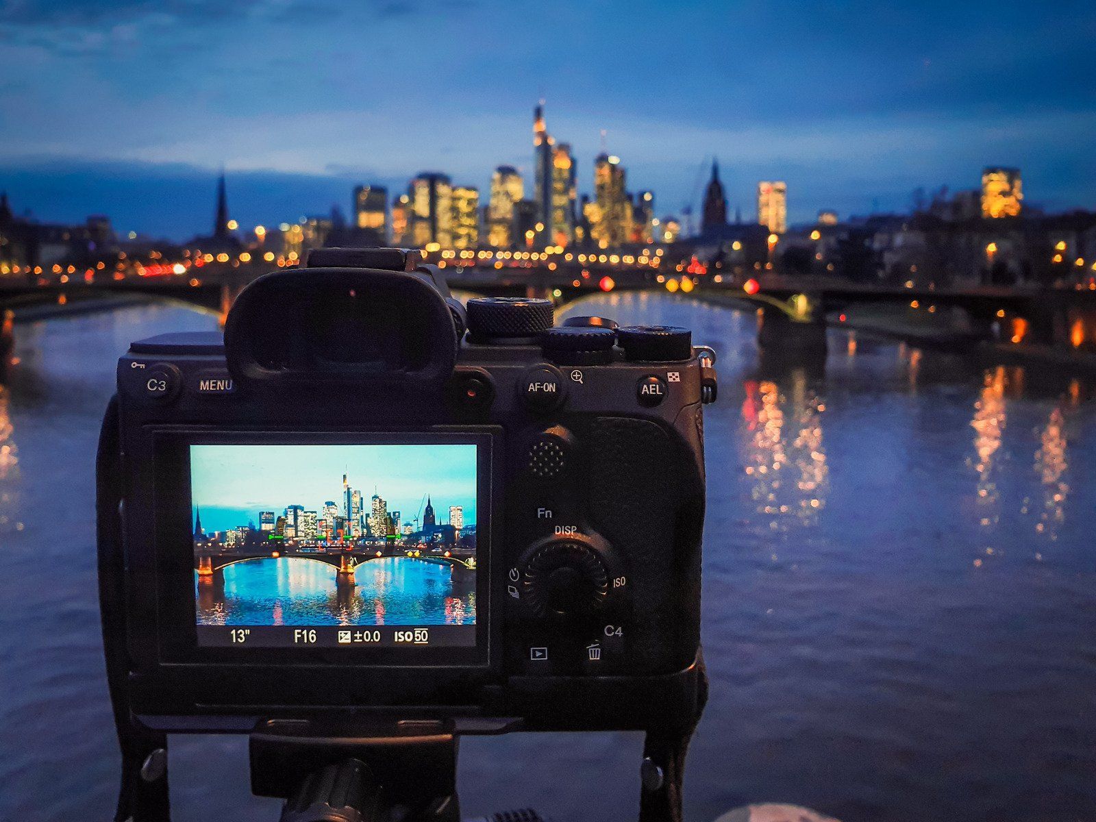 A camera is taking a picture of a city at night
