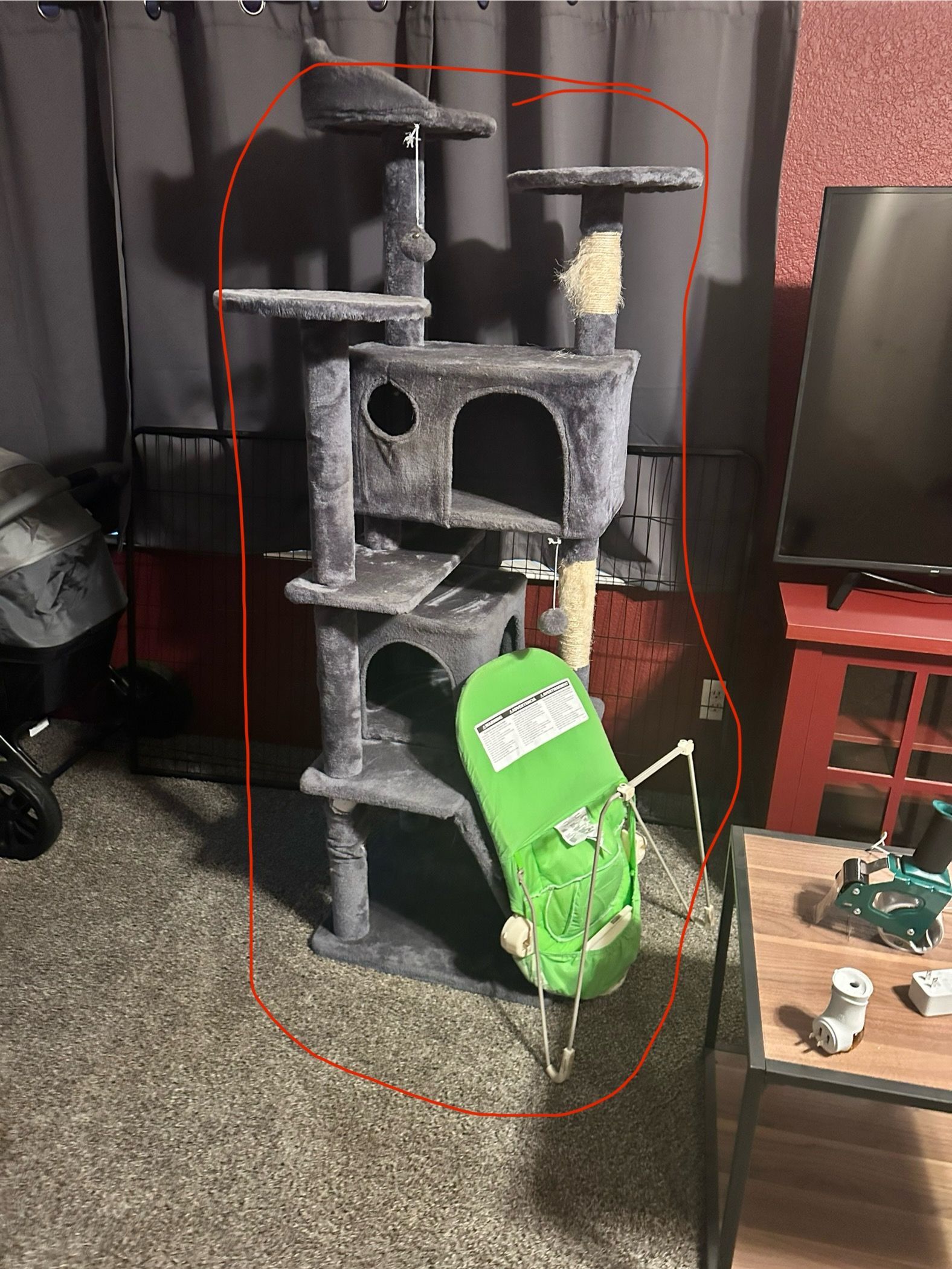 Cat tree in a room with a green tag hanging on it.