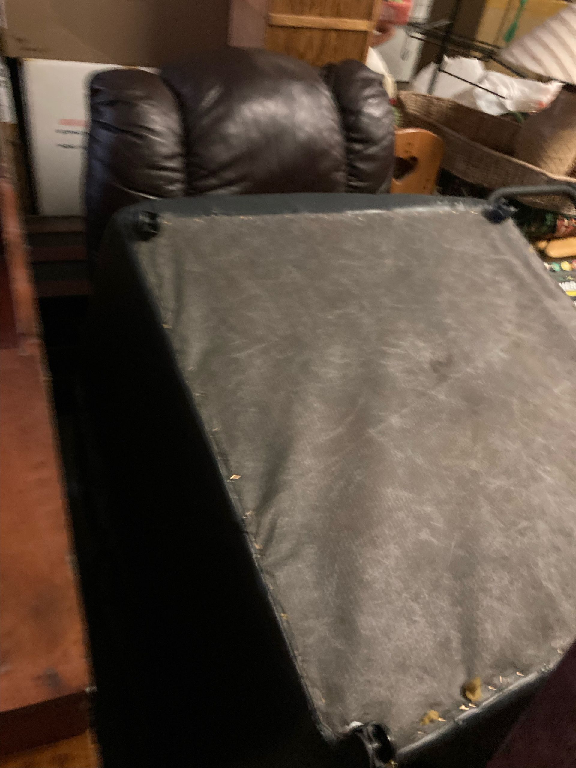 Dark brown recliner with exposed black underside.