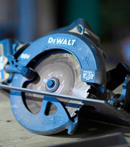A dewalt circular saw is sitting on a wooden table