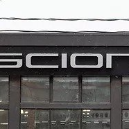 A close up of the front of a scion car dealership.