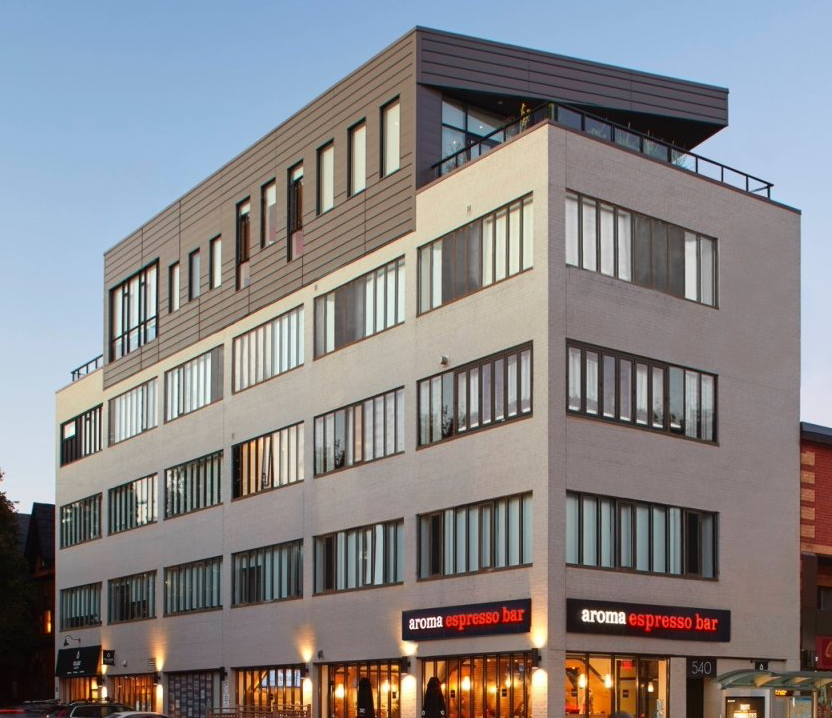 A large building with a sign that says extra espresso bar