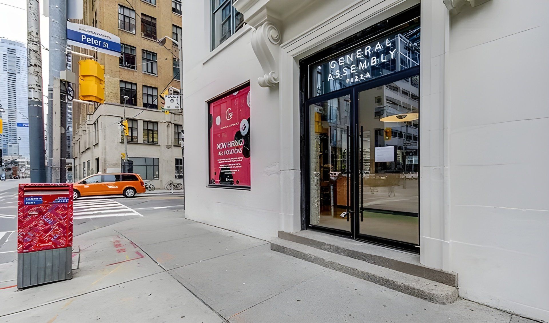 A white building with a red sign on the side of it