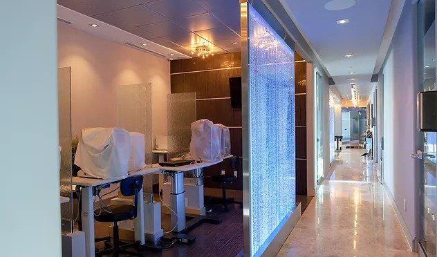 A long hallway with tables and chairs in it