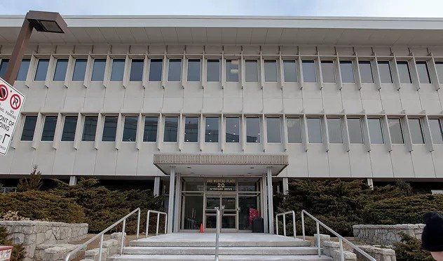 A large building with a lot of windows and stairs leading up to it.