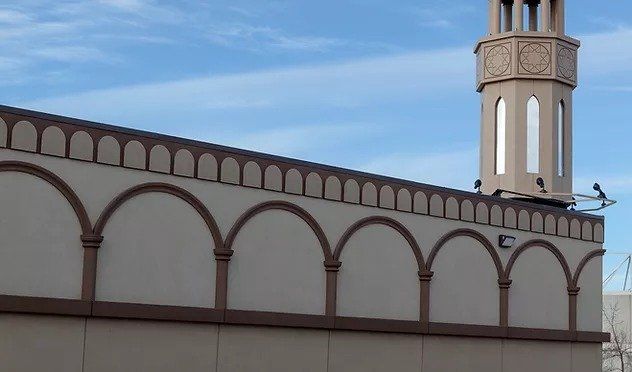 A building with arches and a tower on top of it