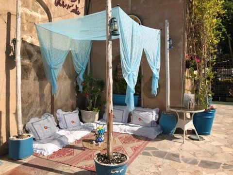 A patio with a canopy and a table and chairs