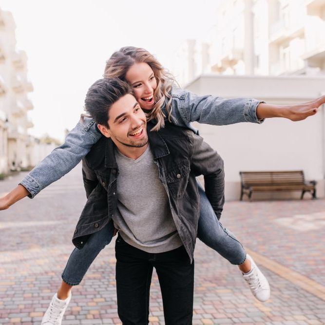 A man is carrying a woman on his back.