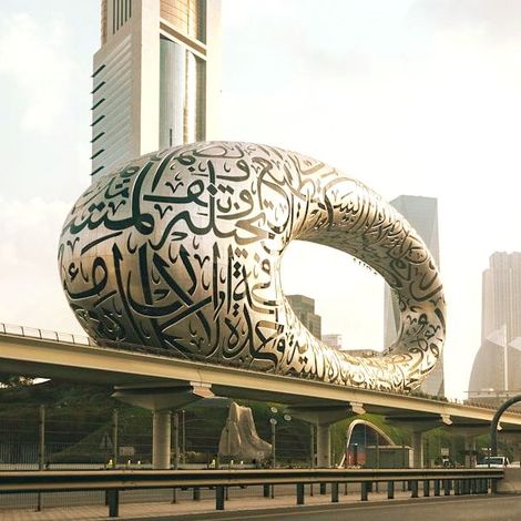 A large sculpture with arabic writing on it