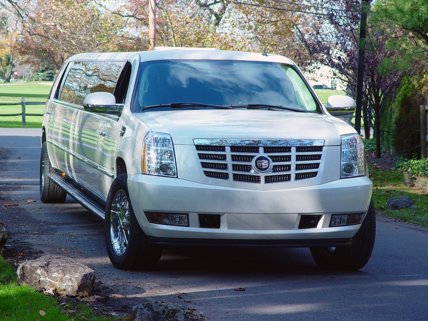 white stretch Cadillac SUV limousine