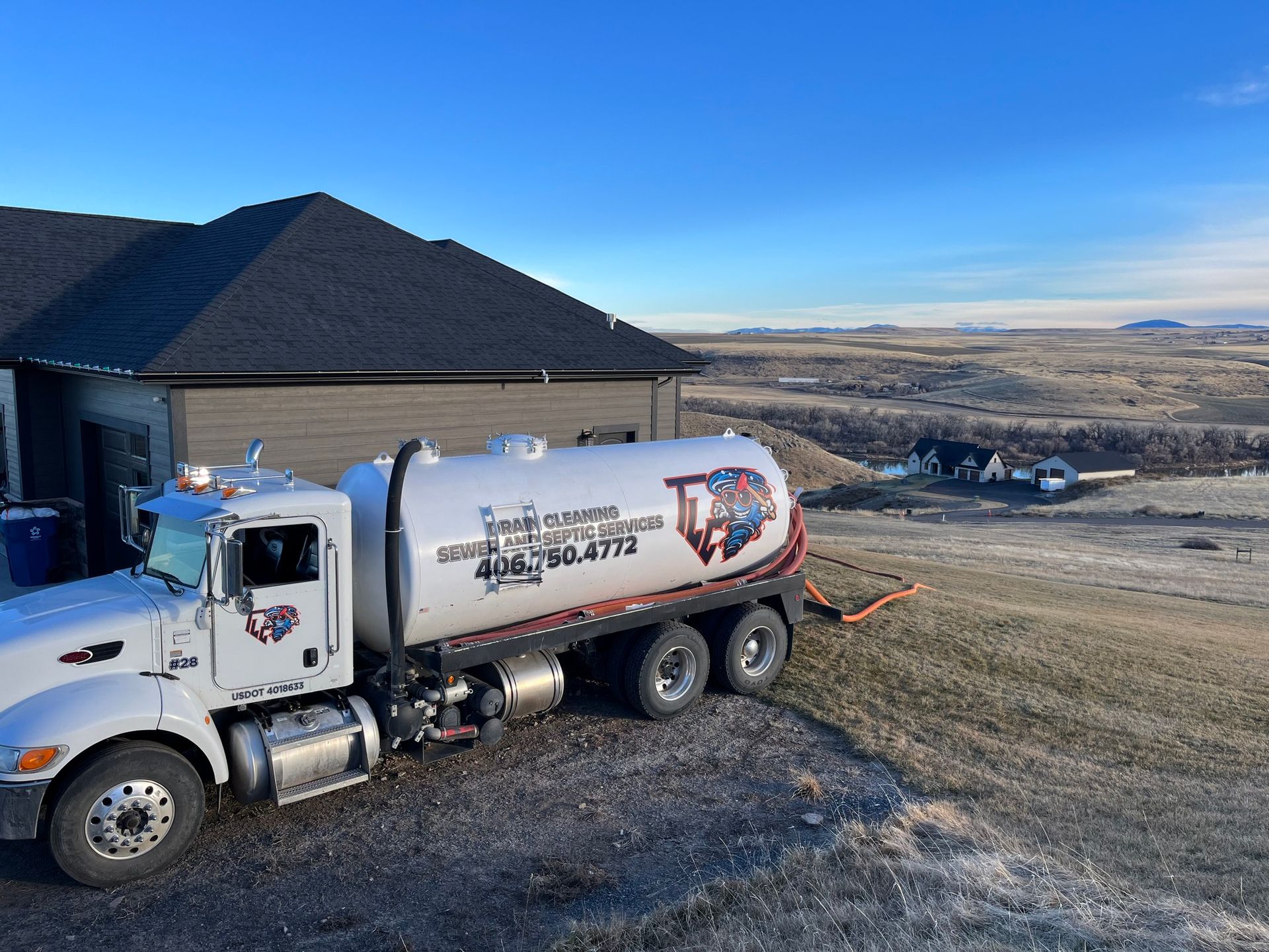 A large white truck is parked in front of a house.