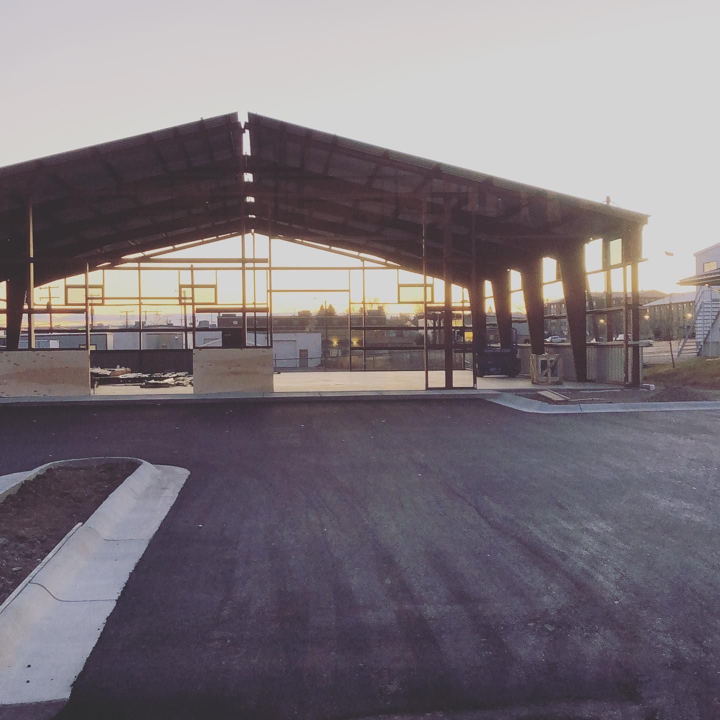 A large building with a roof that has a lot of windows
