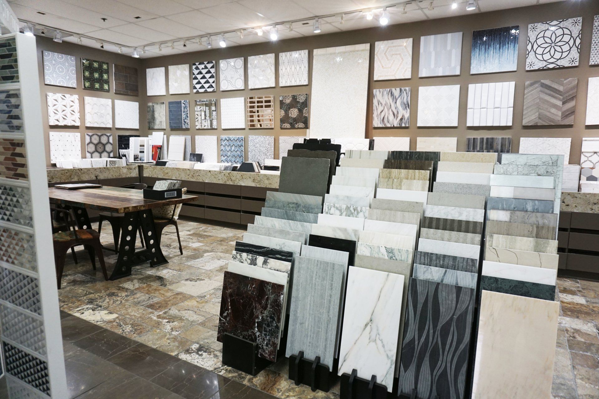 Tile showroom with displays of various tile samples and patterns on walls and racks.