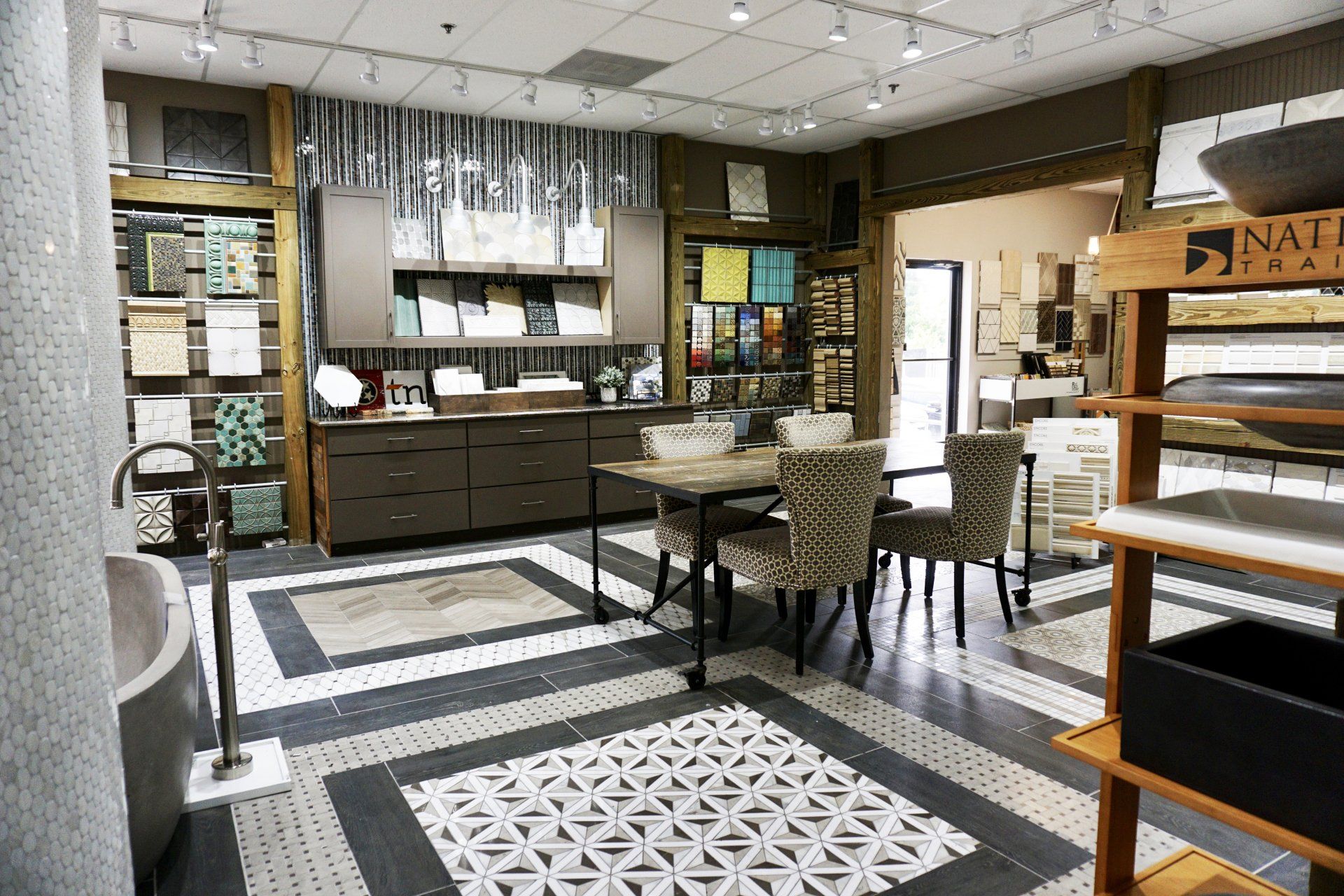 Tile showroom interior, showcasing various tile patterns and bathroom fixtures.