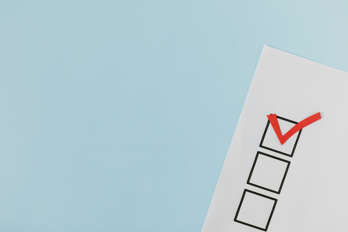 Checklist with one box checked in red on a light blue background.