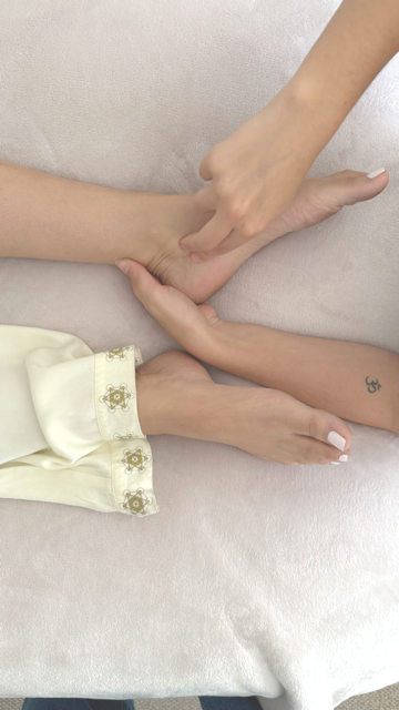 Nikki working with a client's feet on the massage table