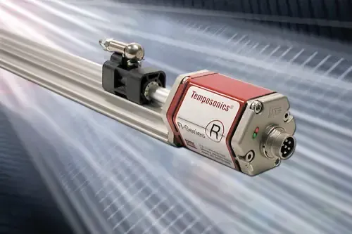 Metallic industrial sensor mounted on a rail, with a red-and-silver housing on a motion-blur background