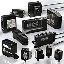 Assorted black electronic sensors and photoelectric switches displayed on a white background
