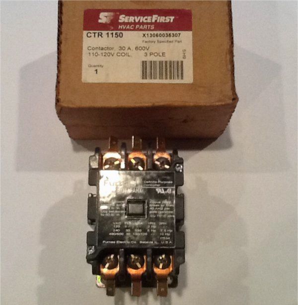 Electrical relay on a box, with visible copper contacts and a ServiceFirst label