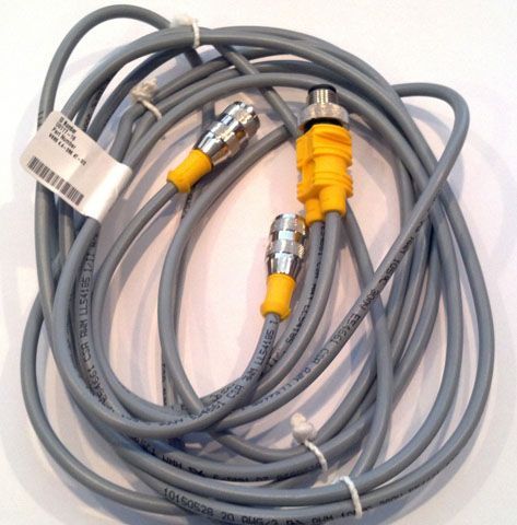 Coiled gray cable with yellow and silver connectors on a white background